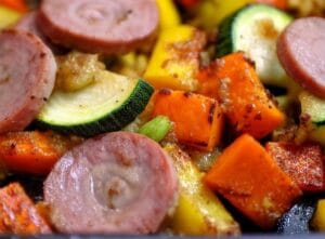 Sliced chicken apple sausage with sautéed zucchini, yellow squash, and sweet potatoes.